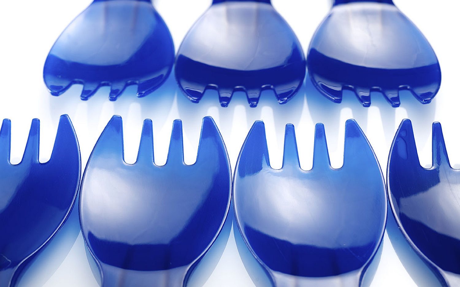 3 blue plastic utensils on a white background Envato